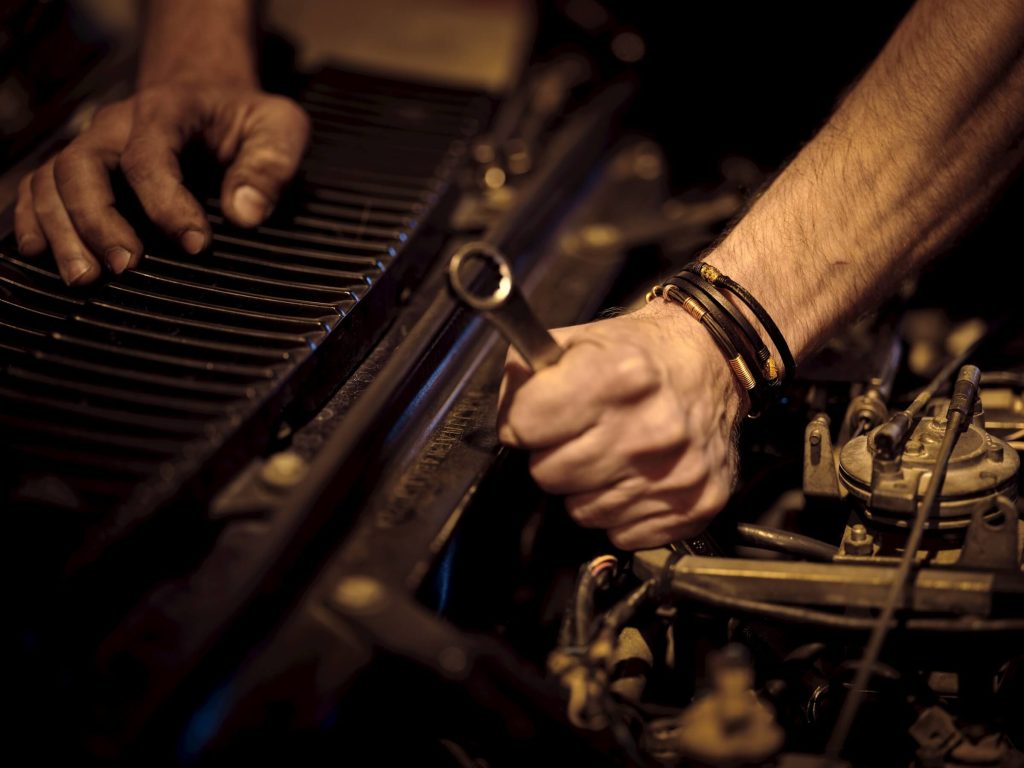 remap warrington 5 hands holding wrench repairing engine